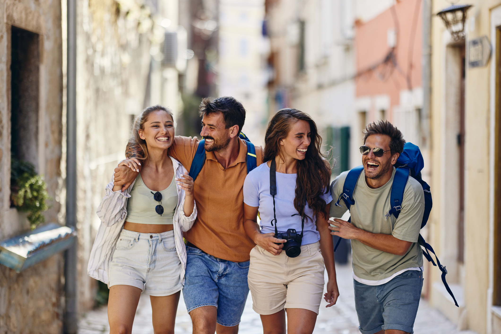Young adults traveling together through a European city, reflecting friendship, independence, financial freedom, and life experiences associated with young adulthood, financial confidence, and building a meaningful future.