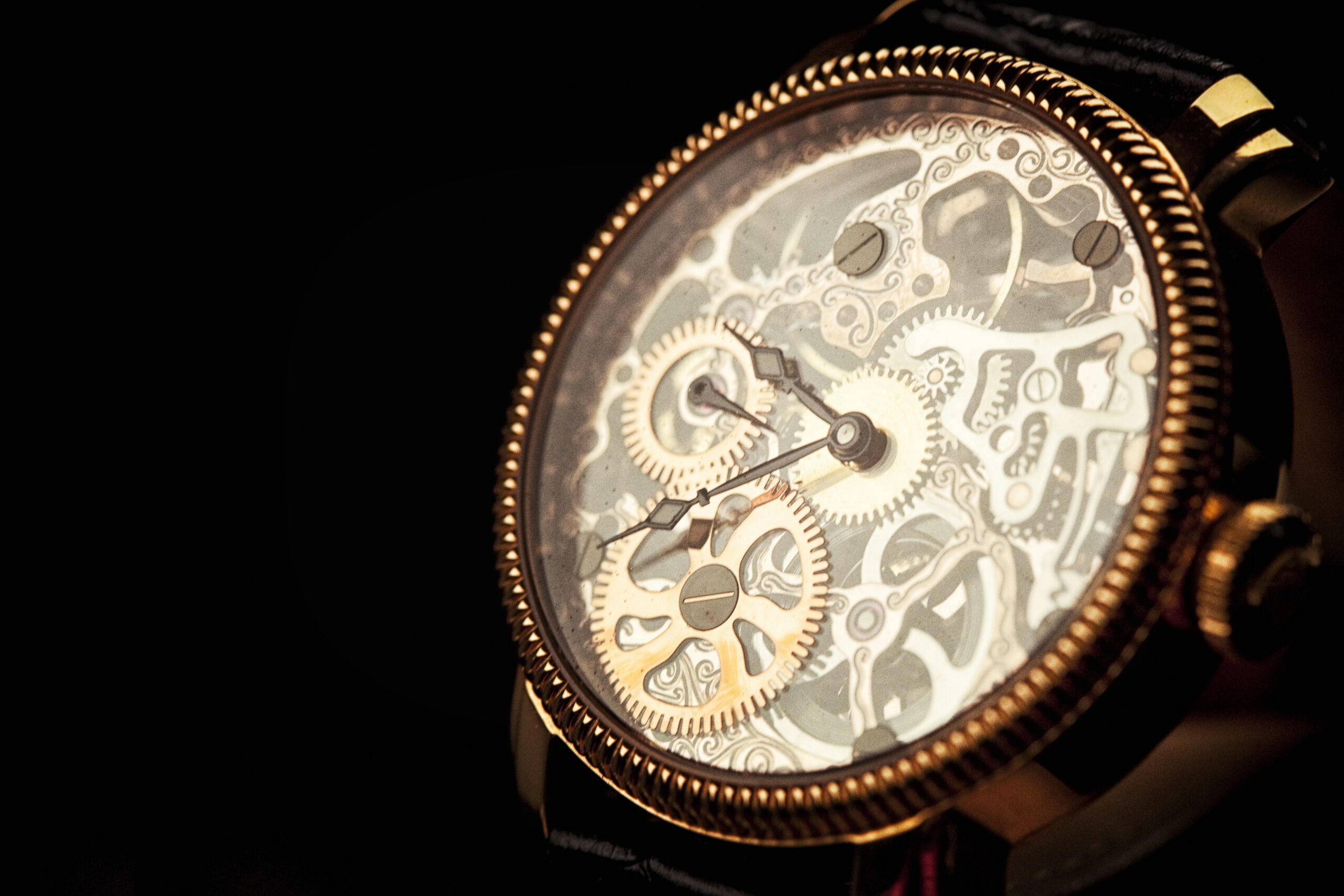 Close-up of a luxury mechanical watch revealing intricate gears, symbolizing actuarial expertise in estate planning and the complexity behind life insurance illustrations.